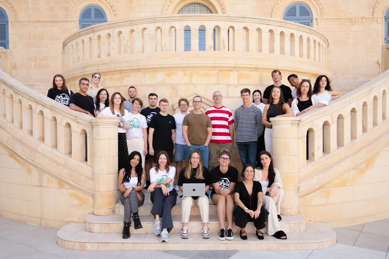 Big group of people sitting on stairs